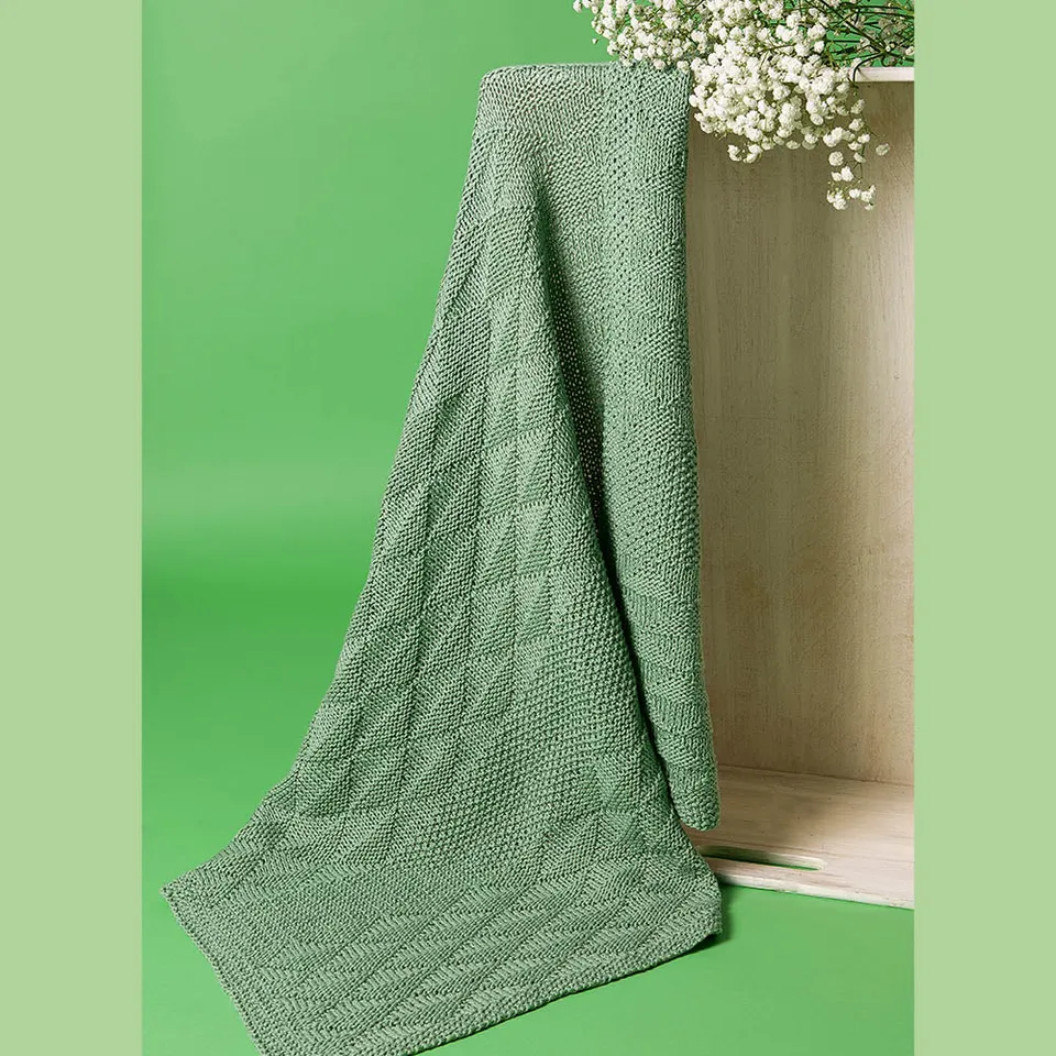 pascuali-nola-babydecke-strickanleitung-perlmuster-grafikmuster-6x-sole image 1